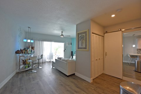 a living room and dining room with a white couch and a table